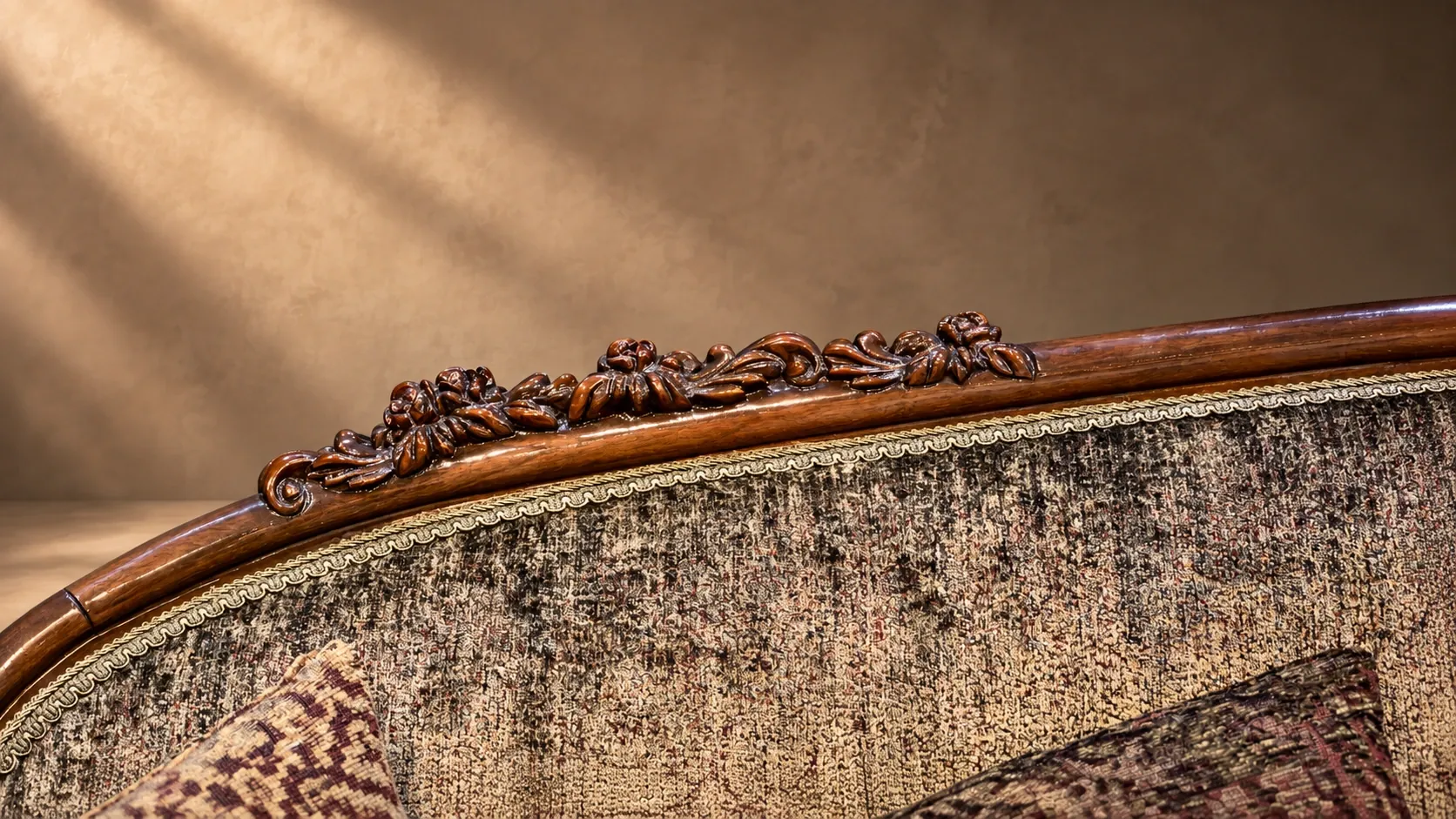 Rose-and-leaf crest carving on the Flor sofa