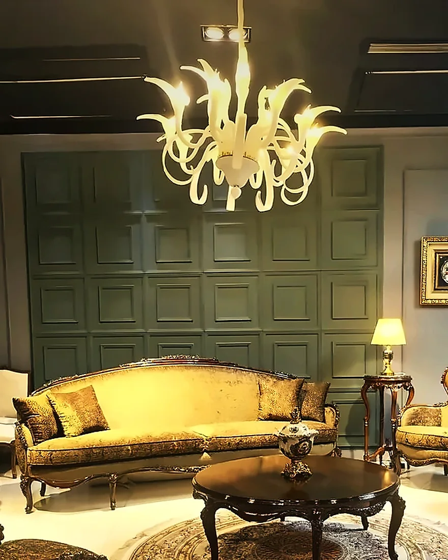 Sage-green panelling, the white chandelier and the Flor sofa